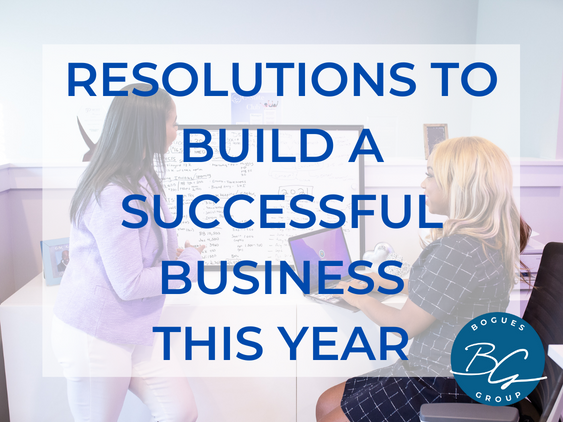 Background features a bright office space with hues of purple. Two women sit at a desk overlooking work documents. Over the picture are the words 'resolutions to build a successful business this year.'